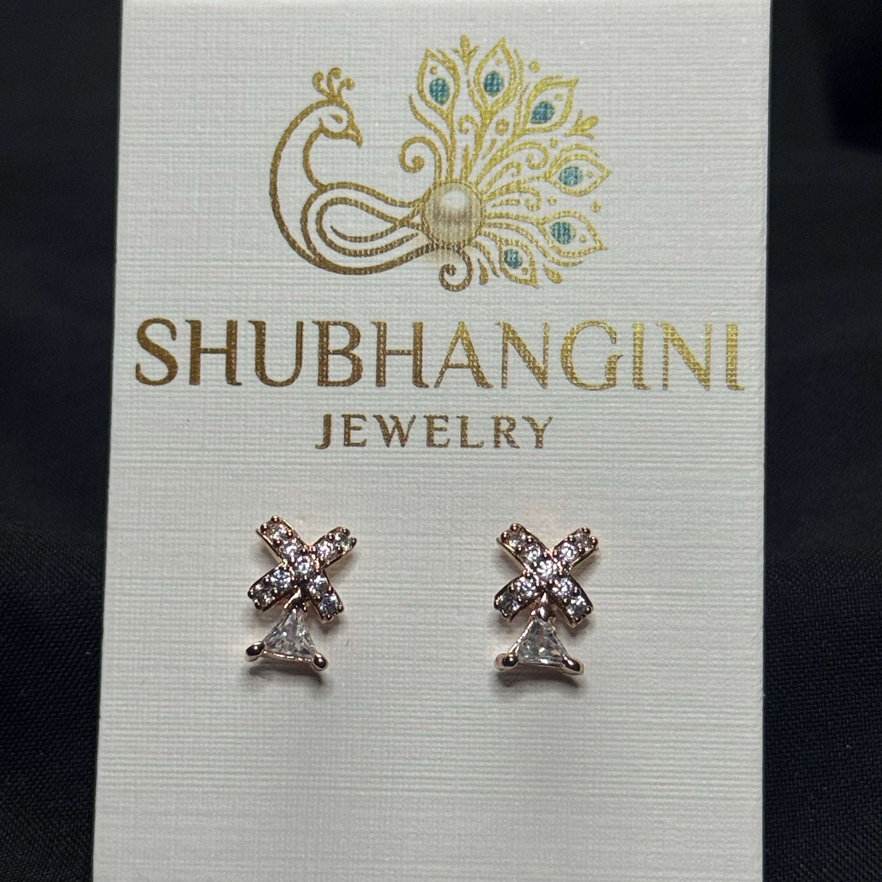 Pair of earrings on a Shubhangini Jewelry card with a black background