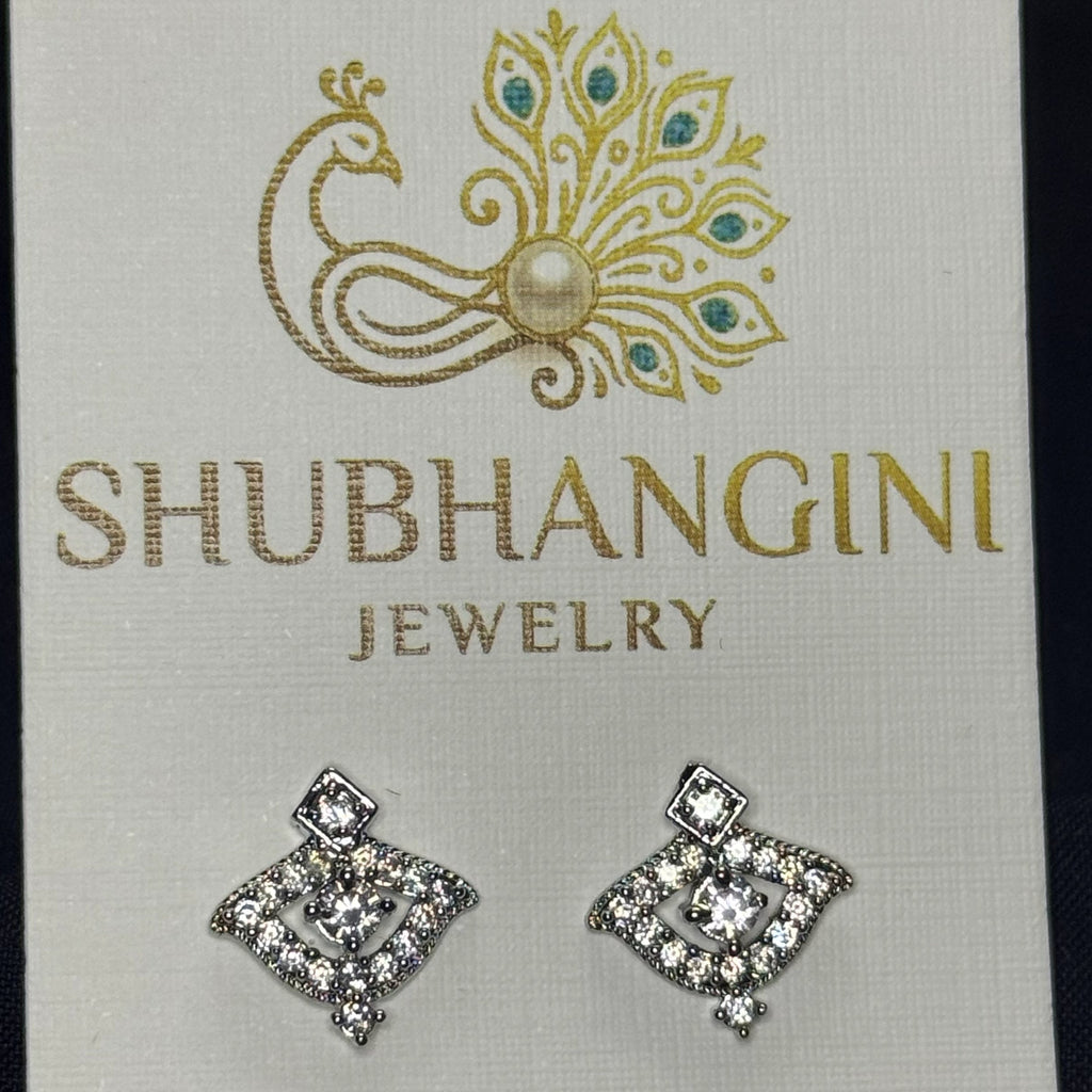 Pair of diamond-shaped earrings on a Shubhangini Jewelry card.