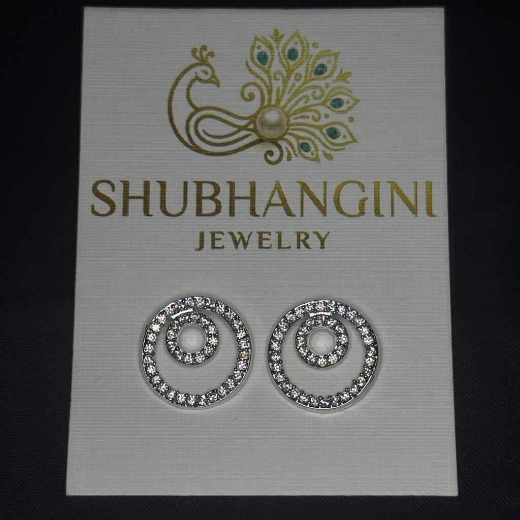 Shubhangini jewelry card with a pair of earrings on a dark background