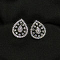 Teardrop-shaped silver earrings with gemstones on a black background