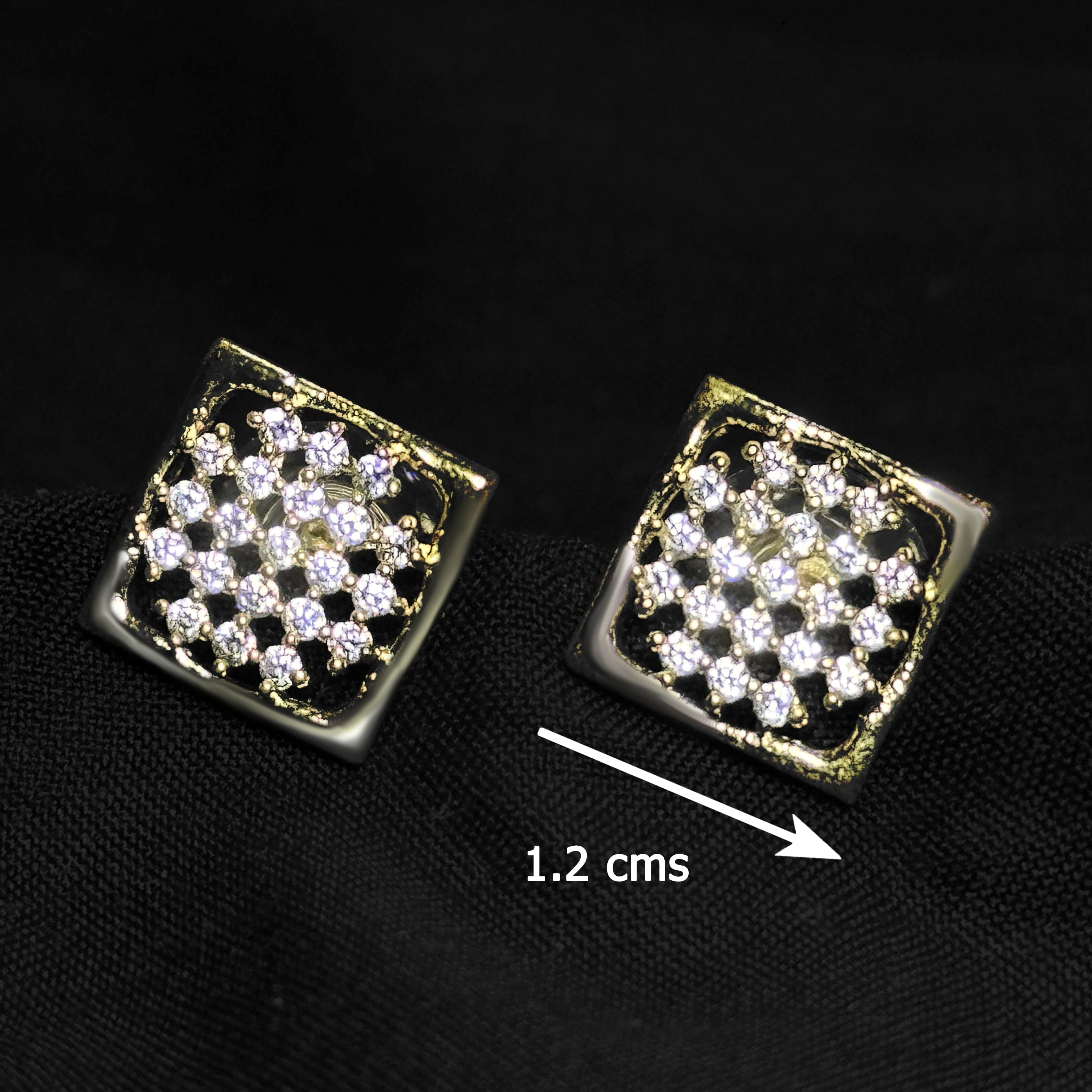 Pair of square-shaped earrings with clear stones on a black background, showing a measurement of 1.2 cm between them.